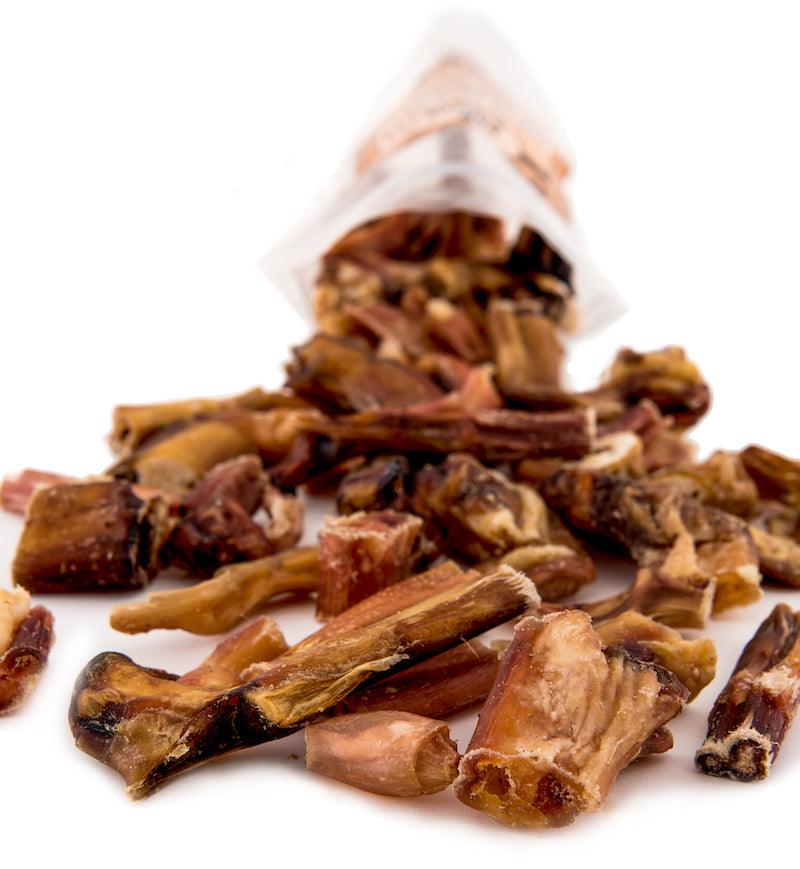 All-natural dog chews spilling from bag, made in USA for safe digestibility